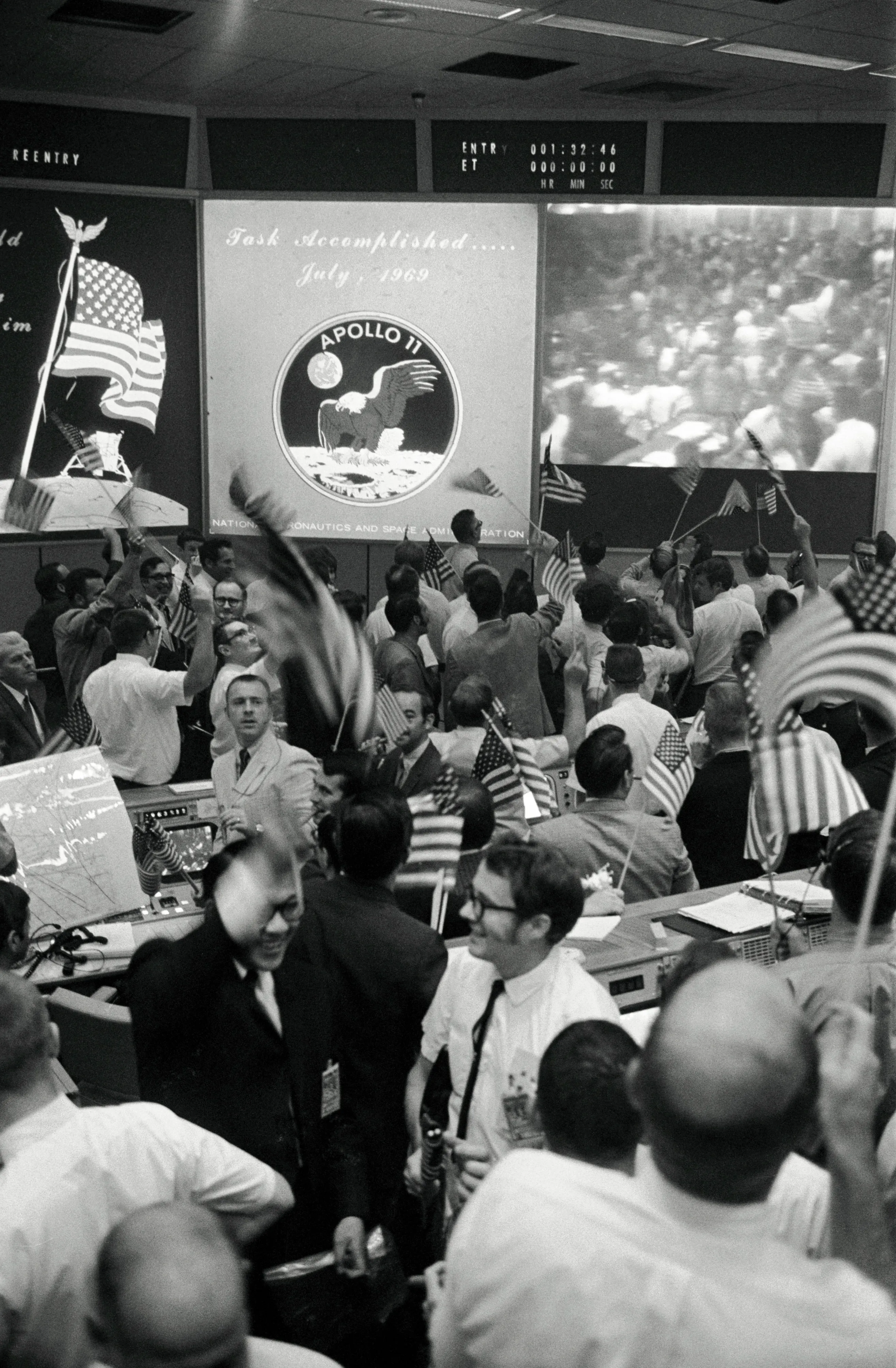 NASA Mission Control in Houston erupts in celebration as Apollo 11 confirms lunar landing, July 1969.